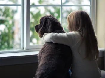 Girl and her dog in the window