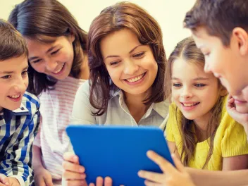 Teacher and students using a tablet