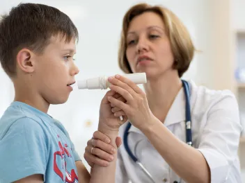 Doctor helping kid with asthma