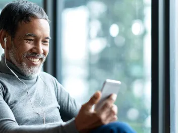 Mature man listening to headphones