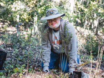 Man planting flowers at volunteer event