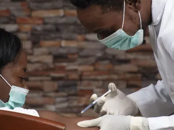 Doctor giving patient a vaccine