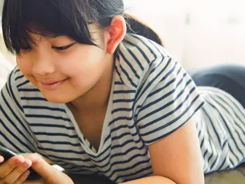 Young girl looking at a cell phone