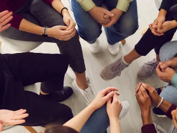 People sitting in a circle talking.