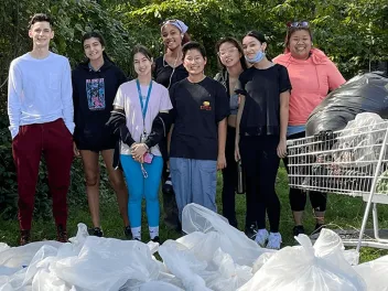 youth volunteers on standing with filled garbage bags on National Public Lands Day